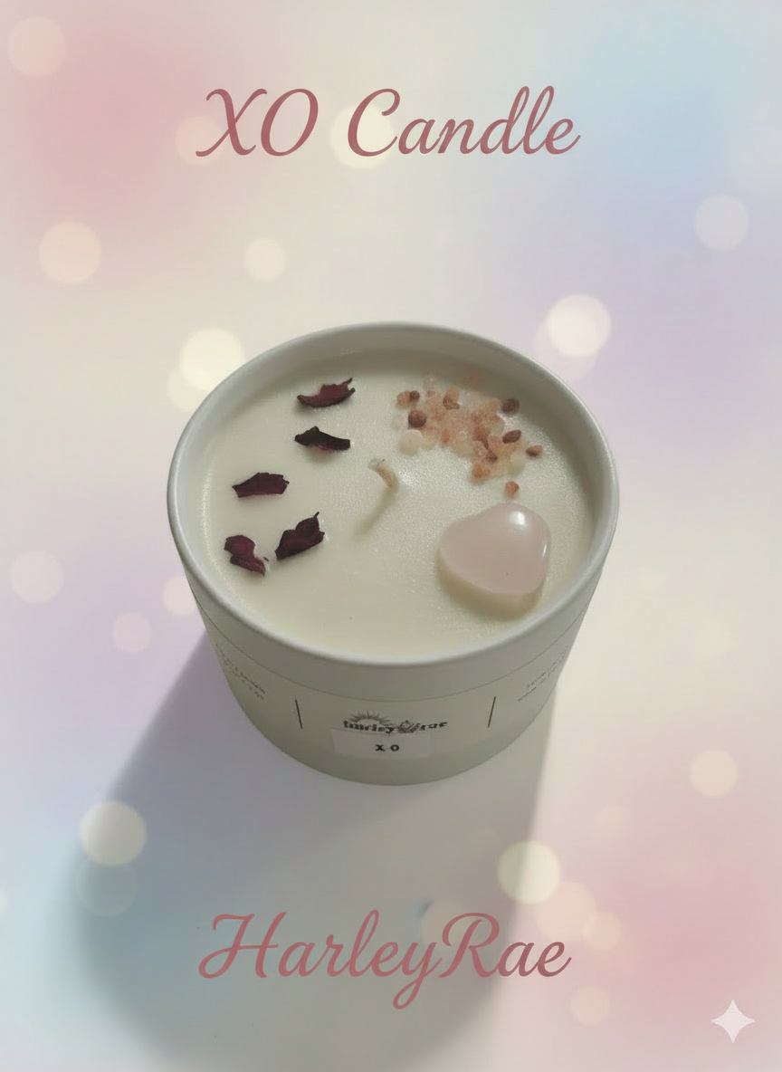 XO Candle in a white container with decorative elements on a light surface