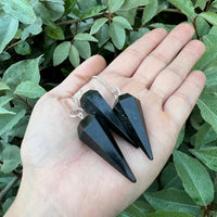 HarleyRae holding two black Tourmaline pendulums 