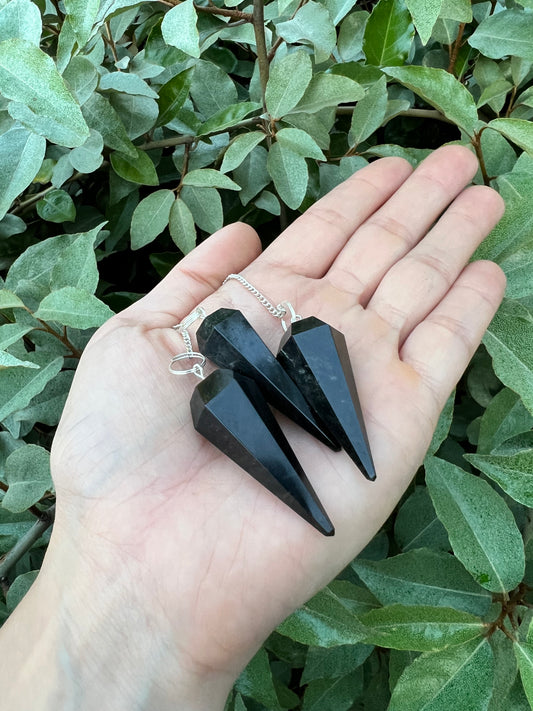 HarleyRae holding two black Tourmaline pendulums 