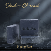 Two blocks of Obsidian Charcoal soap on a dark marble surface with 'HarleyRae' branding.
