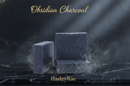 Two blocks of Obsidian Charcoal soap on a dark marble surface with 'HarleyRae' branding.