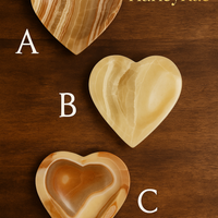 Three heart-shaped wooden trivets labeled A, B, and C on a wooden background with HarleyRae branding.