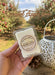 Caramel Apple soy wax melt in a decorative apple orchard background.